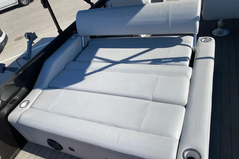 Slide: The Image of 2024 Bentley Pontoons Legacy Swingback with luxurious white seating and cup holders. - 6