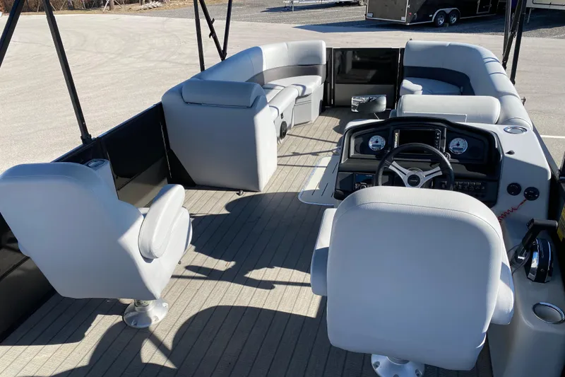 Slide: The Image of 2024 Bentley Pontoons Legacy Swingback interior with plush seating and modern dashboard. - 8