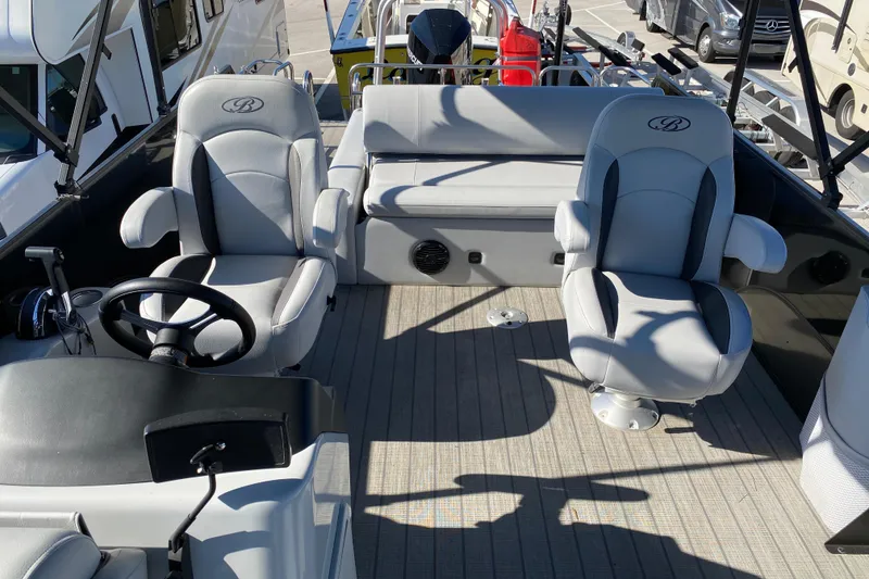 Slide: The Image of 2024 Bentley Pontoons Legacy Swingback interior with plush seating and modern steering console. - 9