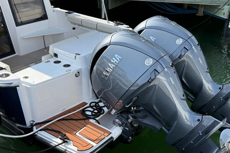 Slide: The Image of 2026 Ranger Tugs R-27 with dual Yamaha outboard motors, docked at marina. - 3