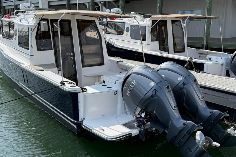 Slide: The Image of 2026 Ranger Tugs R-27 boat with dual Yamaha outboard engines docked in marina. - 4
