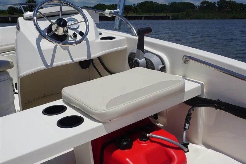 Slide: The Image of Manufacturer Provided Image: 2025 Boston Whaler 130 Super Sport boat interior with steering wheel and seating. - 10