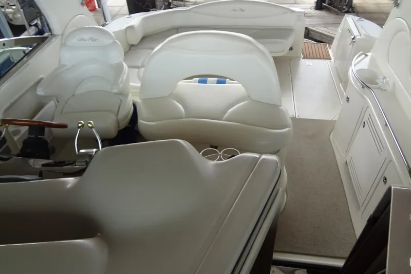 Slide: The Image of Interior of a 2001 Sea Ray 380 Sundancer boat with white seating and helm. - 12