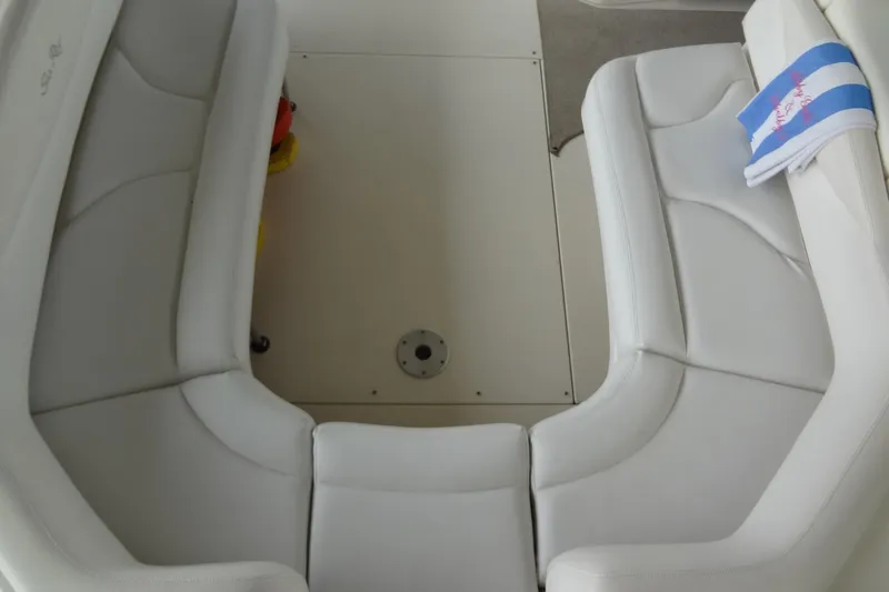 Slide: The Image of 2001 Sea Ray 380 Sundancer interior seating with white upholstery and towel. - 13