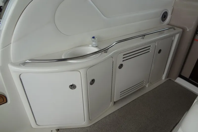Slide: The Image of 2001 Sea Ray 380 Sundancer interior with sink and storage cabinets. - 14