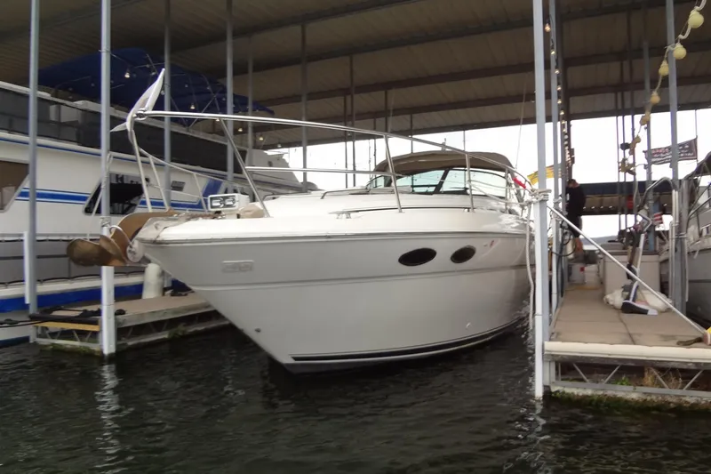 Slide: The Image of 2001 Sea Ray 380 Sundancer docked in a covered marina, front view. - 2
