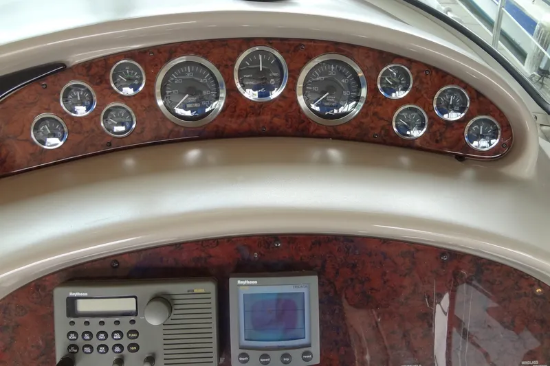 Slide: The Image of Dashboard of a 2001 Sea Ray 380 Sundancer with gauges and navigation equipment. - 23