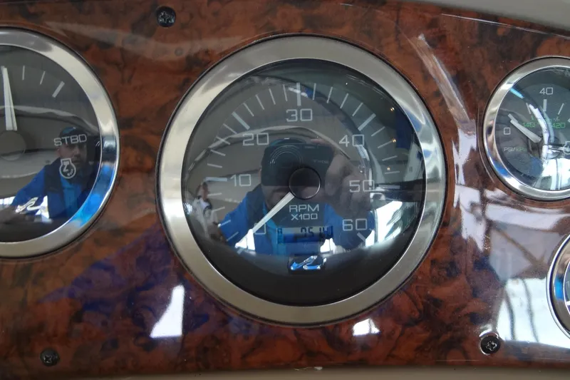 Slide: The Image of Close-up of 2001 Sea Ray 380 Sundancer dashboard gauges, featuring RPM and pressure indicators. - 25