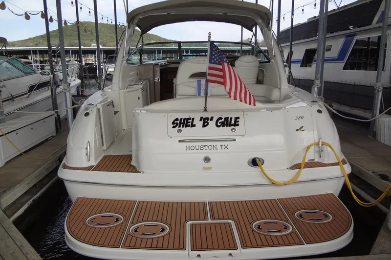 Slide: The Image of 2001 Sea Ray 380 Sundancer docked, featuring teak deck and American flag. - 3