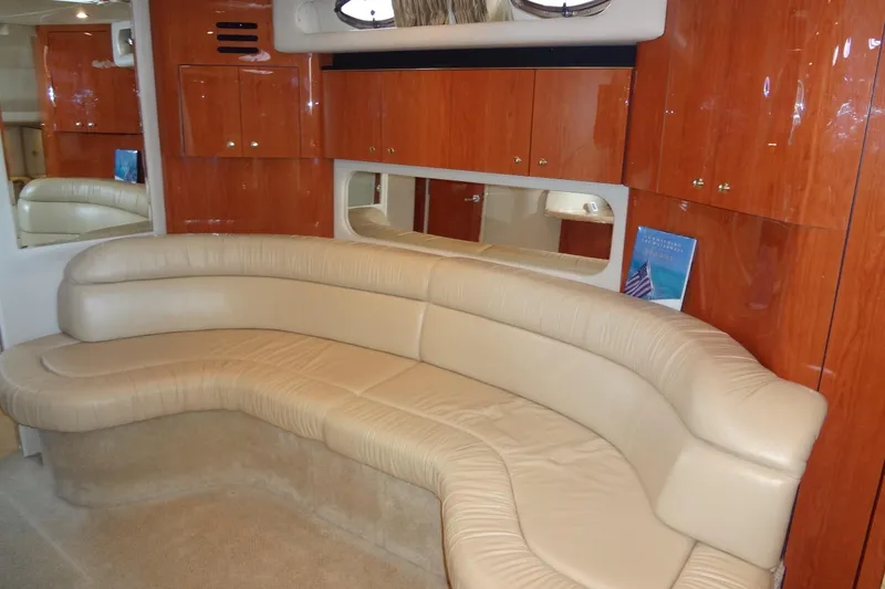 Slide: The Image of Luxurious interior of 2001 Sea Ray 380 Sundancer with beige leather seating and wooden cabinets. - 37