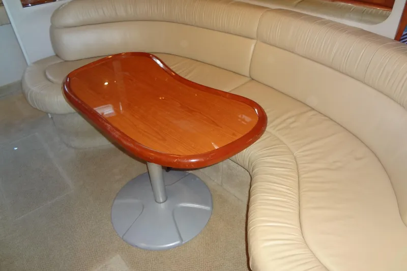 Slide: The Image of Interior of 2001 Sea Ray 380 Sundancer with beige leather seating and wooden table. - 39