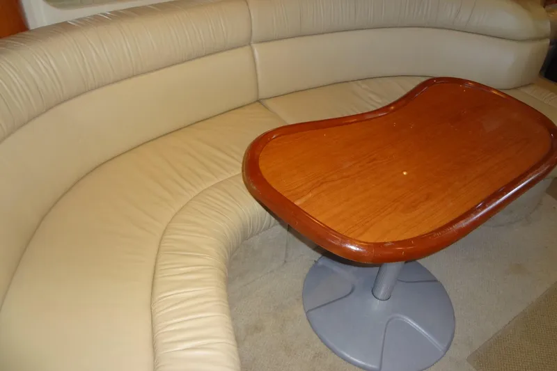 Slide: The Image of Interior of 2001 Sea Ray 380 Sundancer with beige leather seating and wooden table. - 40