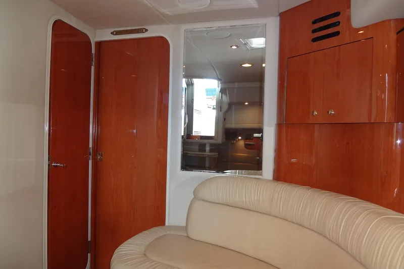Slide: The Image of Interior of 2001 Sea Ray 380 Sundancer with wood paneling and cream seating. - 42
