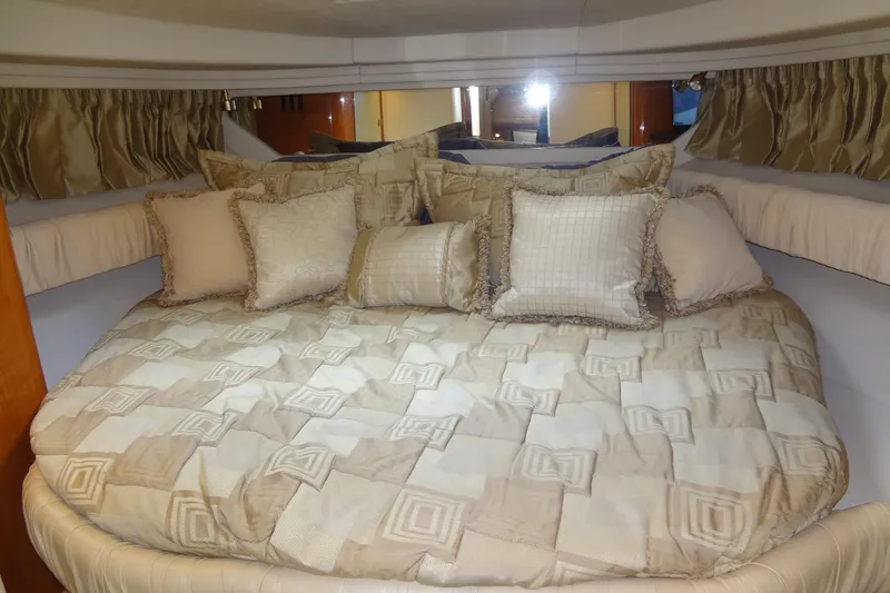 Slide: The Image of Luxurious cabin interior of 2001 Sea Ray 380 Sundancer with plush bedding and pillows. - 43