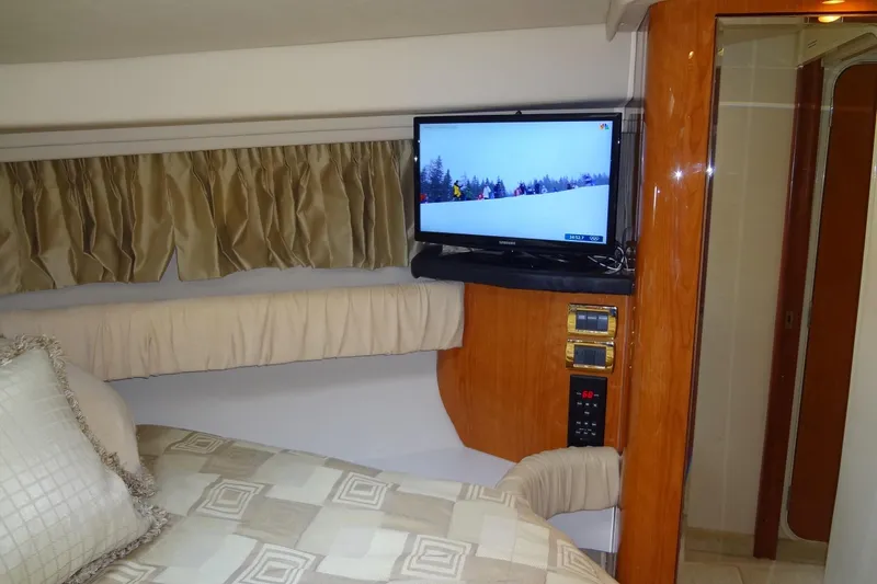 Slide: The Image of Interior of 2001 Sea Ray 380 Sundancer with TV, bed, and wood paneling. - 45