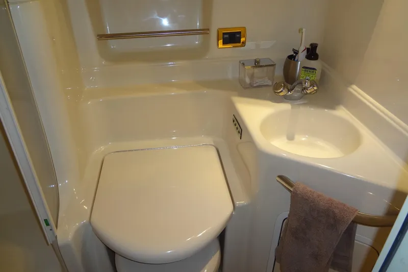 Slide: The Image of Compact bathroom in 2001 Sea Ray 380 Sundancer yacht with sink and toilet. - 47