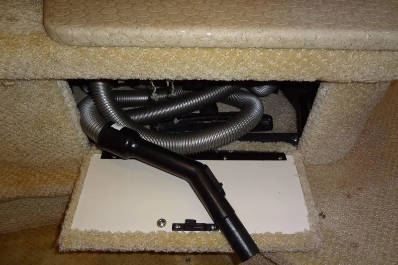 Slide: The Image of 2001 Sea Ray 380 Sundancer interior showing vacuum hose and carpeted compartment. - 52