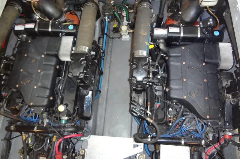 Slide: The Image of Engine compartment of a 2001 Sea Ray 380 Sundancer, showcasing dual inboard engines. - 53