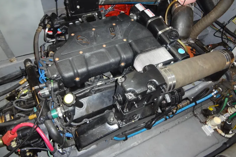 Slide: The Image of Engine of a 2001 Sea Ray 380 Sundancer boat, showcasing intricate mechanical components. - 54