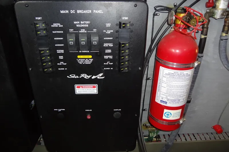Slide: The Image of Main DC breaker panel and fire extinguisher on 2001 Sea Ray 380 Sundancer boat. - 58