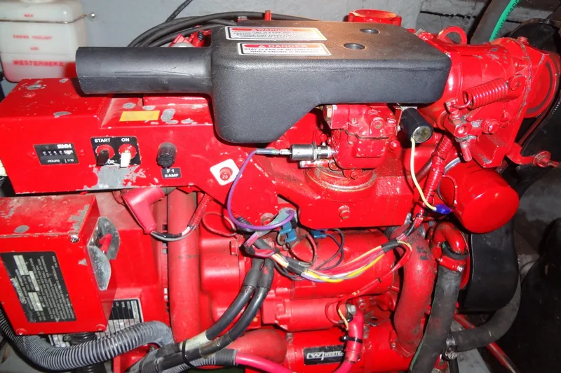Slide: The Image of Red engine compartment of a 2001 Sea Ray 380 Sundancer boat, featuring wiring and controls. - 59