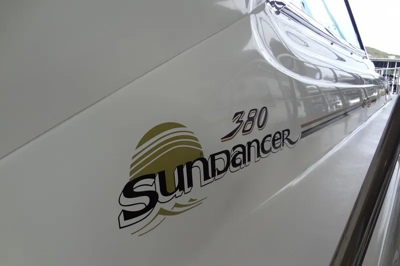 Slide: The Image of 2001 Sea Ray 380 Sundancer boat logo on sleek white hull. - 6