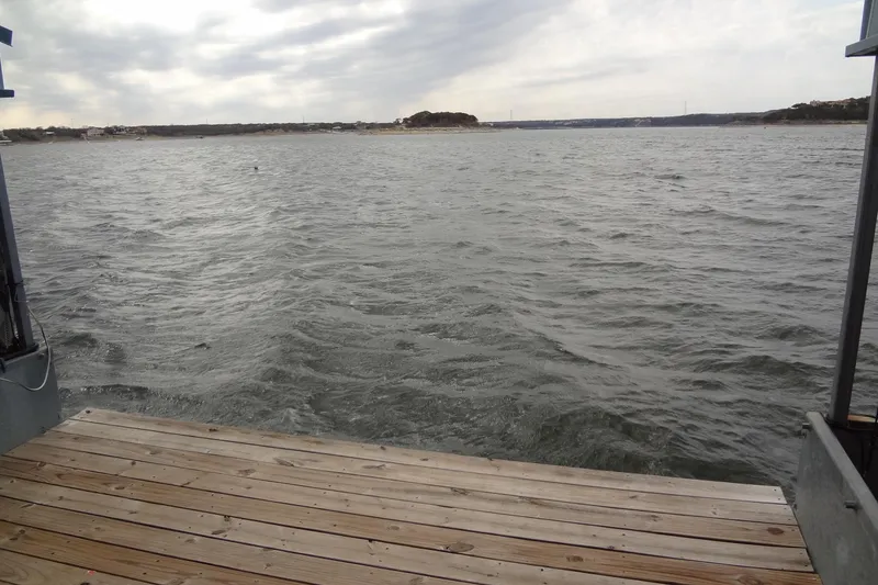 Slide: The Image of Wooden dock overlooking a cloudy lake, Sea Ray 380 Sundancer, 2001 model. - 63