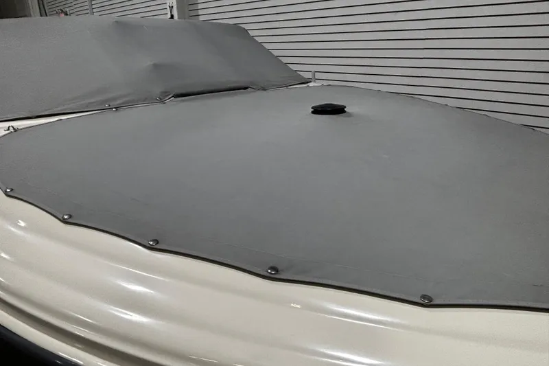 Slide: The Image of 2004 Sea Ray 185 Bow Rider with gray cover in storage. - 10