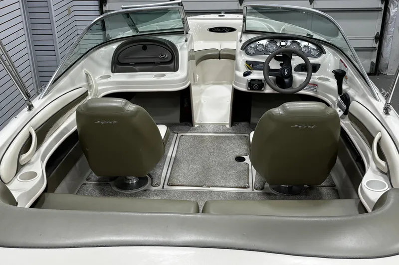 Slide: The Image of 2004 Sea Ray 185 Bow Rider interior with dual seats and dashboard view. - 18