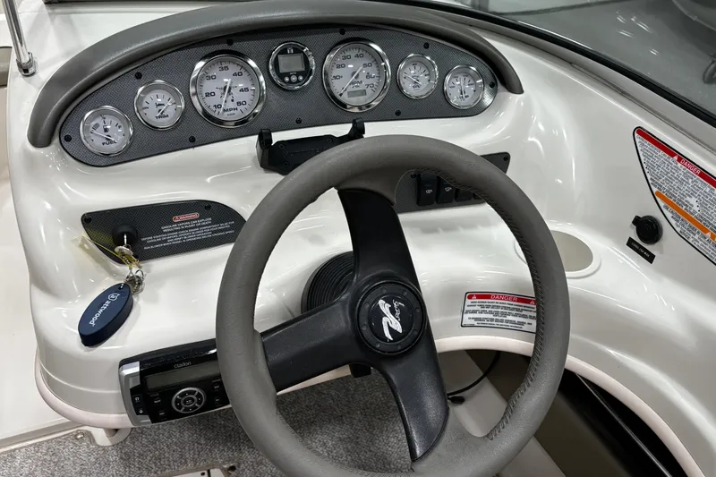 Slide: The Image of Dashboard of 2004 Sea Ray 185 Bow Rider with steering wheel and gauges. - 19