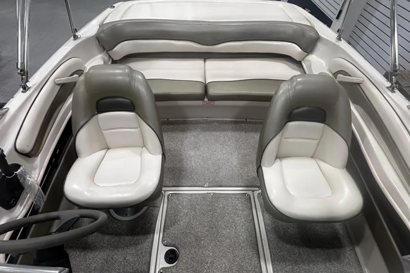 Slide: The Image of 2004 Sea Ray 185 Bow Rider interior with dual seats and rear bench. - 25