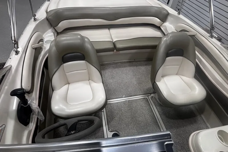 Slide: The Image of 2004 Sea Ray 185 Bow Rider interior with dual seats and cushioned bench. - 26