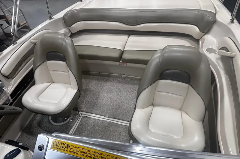 Slide: The Image of 2004 Sea Ray 185 Bow Rider interior with beige and gray seating. - 27