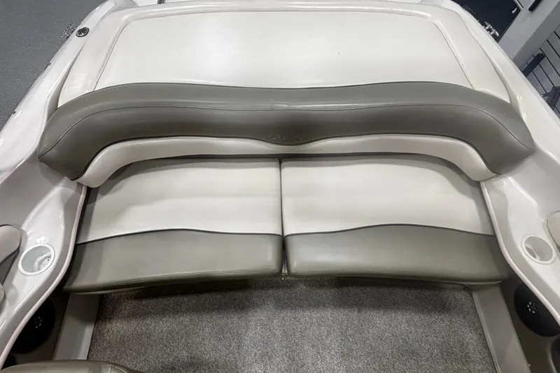 Slide: The Image of 2004 Sea Ray 185 Bow Rider interior seating, featuring gray and white upholstery. - 33