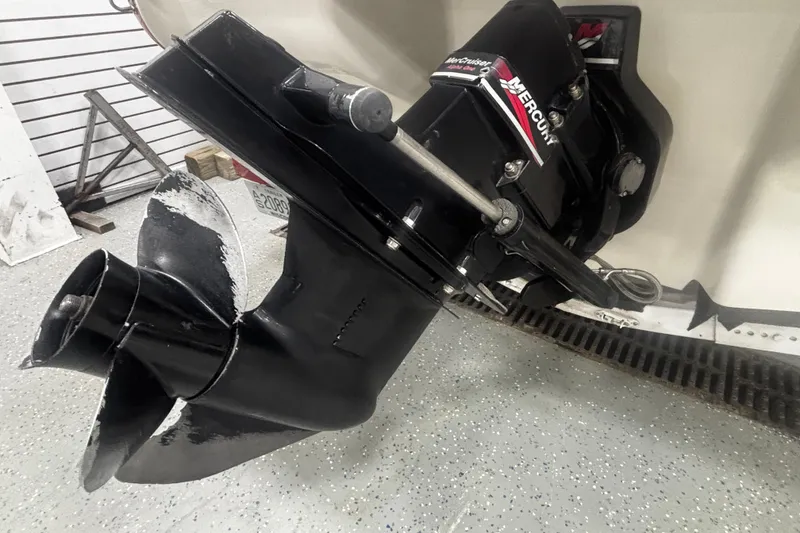 Slide: The Image of 2004 Sea Ray 185 Bow Rider boat propeller and engine detail in a garage setting. - 35