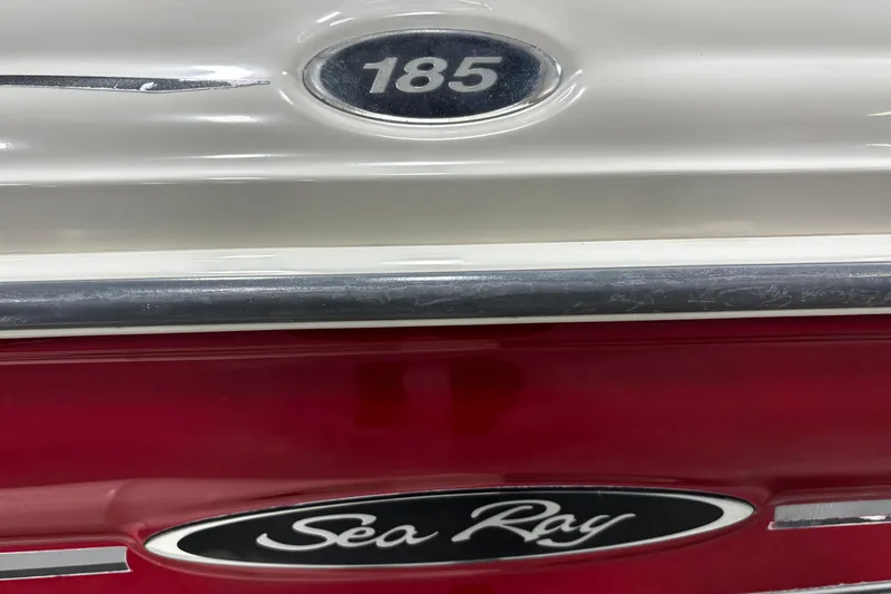Slide: The Image of 2004 Sea Ray 185 Bow Rider boat emblem with red and white detailing. - 36