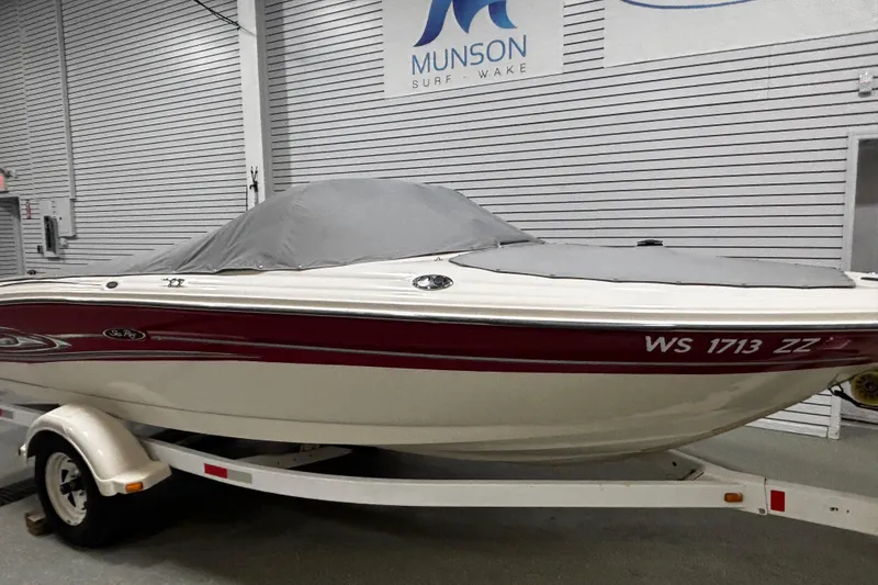 Slide: The Image of 2004 Sea Ray 185 Bow Rider boat on trailer, covered, in indoor storage. - 9