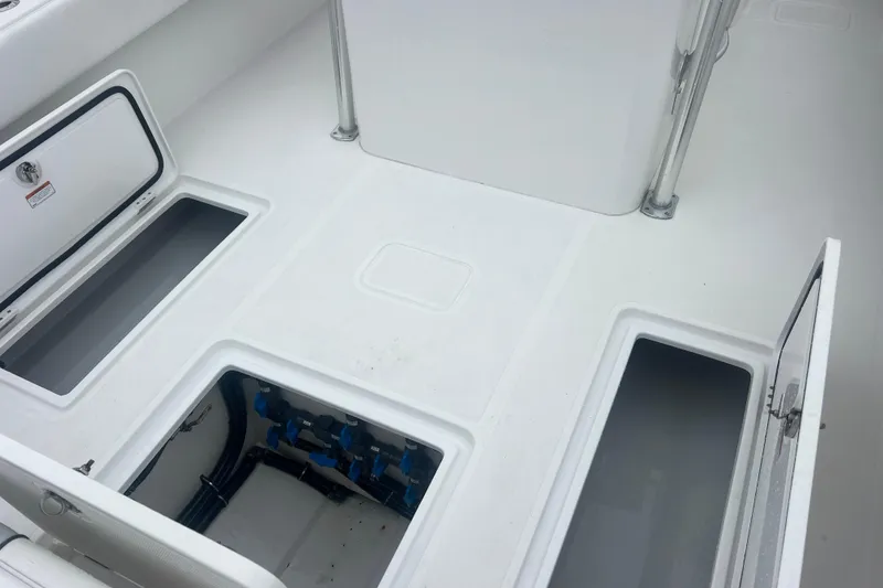 Slide: The Image of 2022 Sea-Lion 34 TE boat deck with open storage compartments and visible plumbing. - 13