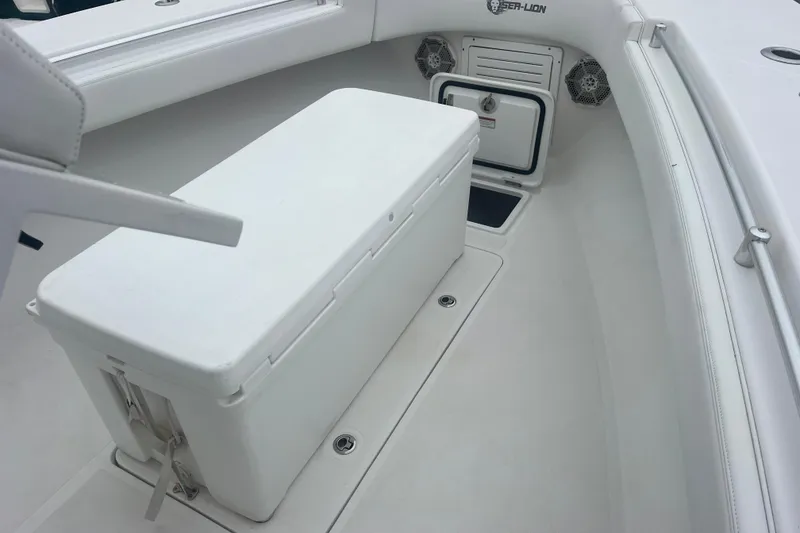 Slide: The Image of 2022 Sea-Lion 34 TE boat interior with storage compartment and speakers. - 16