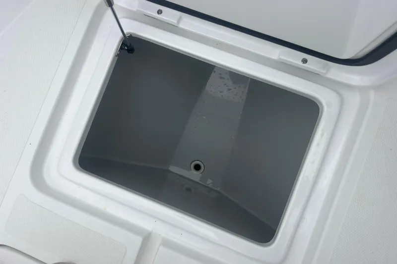 Slide: The Image of Open storage compartment on 2022 Sea-Lion 34 TE boat, featuring a clean, white interior. - 18