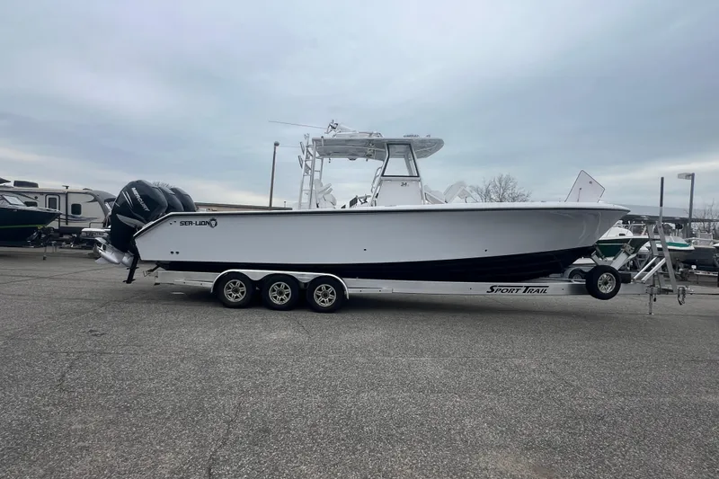Slide: The Image of 2022 Sea-Lion 34 TE boat on trailer, parked in a marina lot. - 2