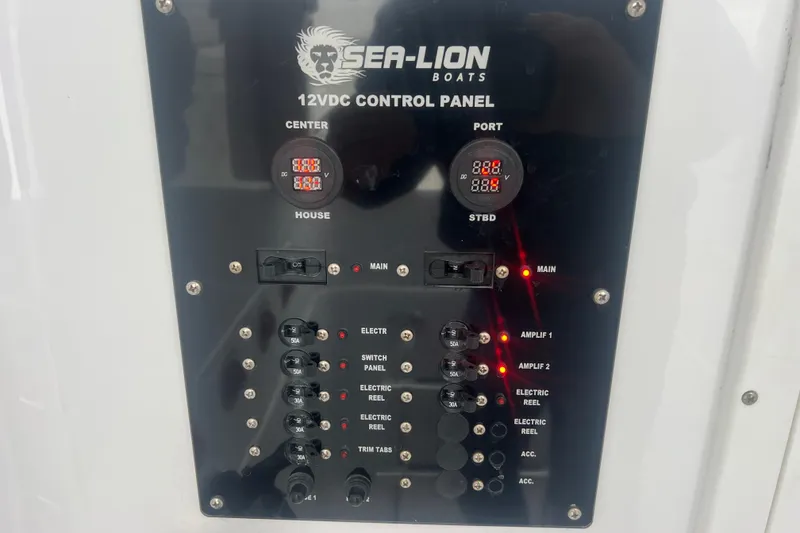 Slide: The Image of Sea-Lion 34 TE 2022 boat control panel with switches and voltage displays. - 23