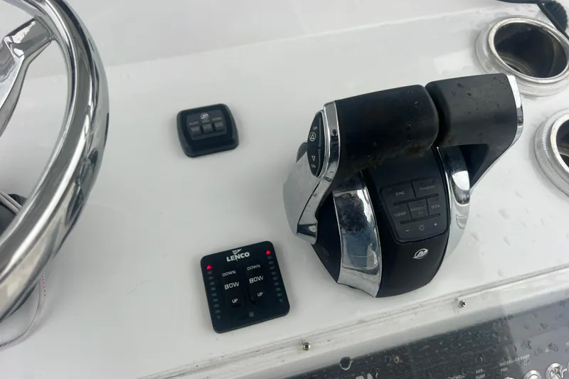Slide: The Image of 2022 Sea-Lion 34 TE boat controls with steering wheel and throttle levers. - 31