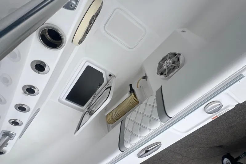 Slide: The Image of 2022 Sea-Lion 34 TE boat interior with rod holders, speaker, and storage compartment. - 34