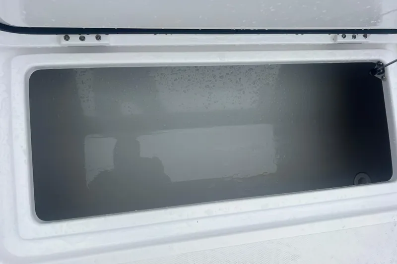 Slide: The Image of Open storage compartment on 2022 Sea-Lion 34 TE boat, showing interior space. - 38