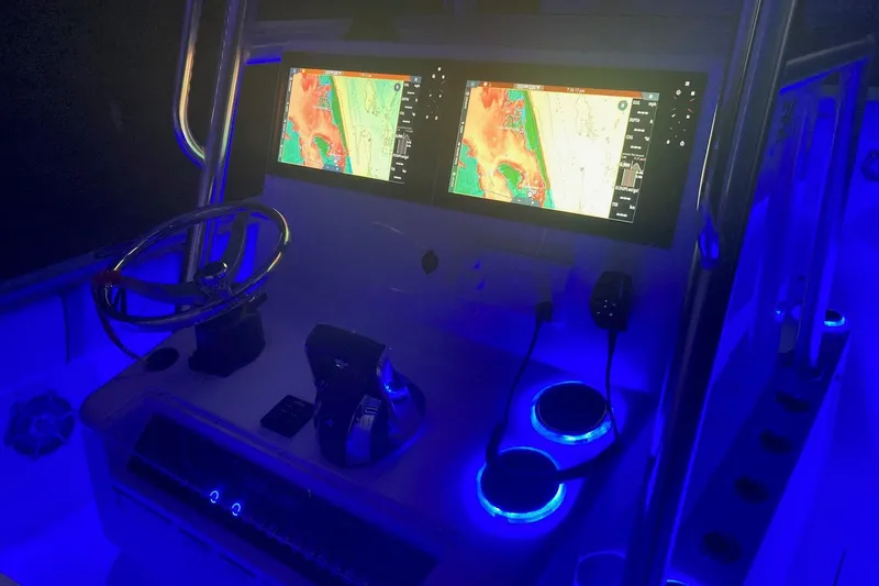 Slide: The Image of 2022 Sea-Lion 34 TE boat dashboard with illuminated navigation screens and controls. - 43