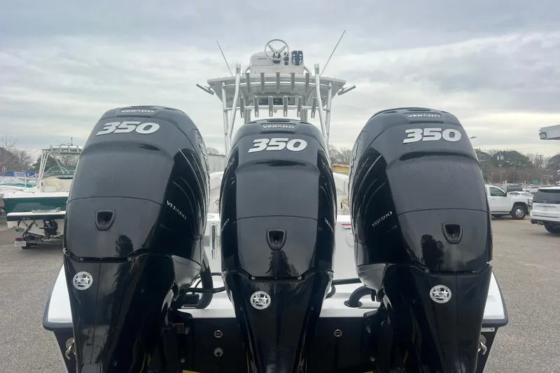 Slide: The Image of Triple 350 Verado engines on a 2022 Sea-Lion 34 TE boat, docked outdoors. - 8