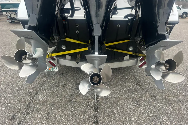 Slide: The Image of Triple outboard motors on a 2022 Sea-Lion 34 TE boat, parked on asphalt. - 9