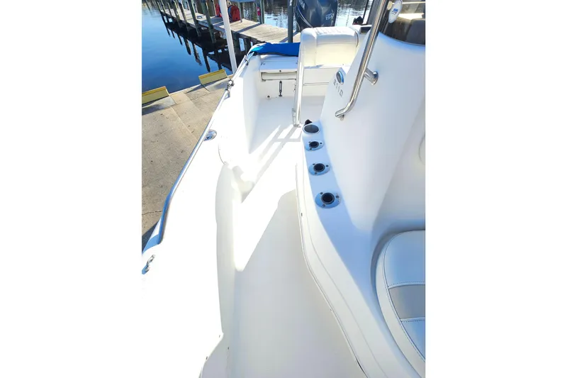 Slide: The Image of 2007 NauticStar 2110 Nautic Bay boat interior with rod holders and seating. - 11