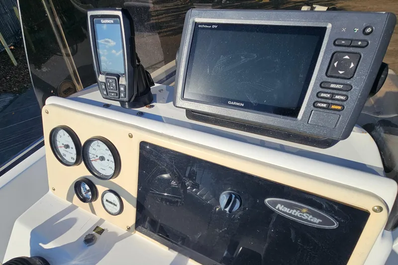 Slide: The Image of 2007 NauticStar 2110 Nautic Bay dashboard with Garmin navigation system and gauges. - 13